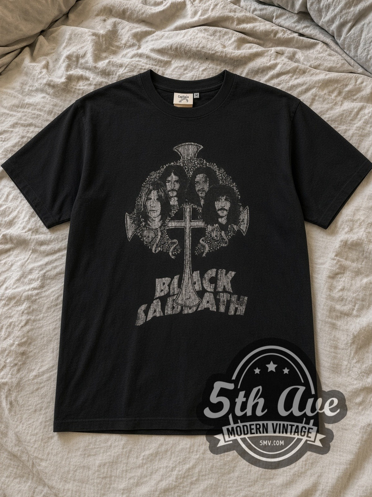 Black Black Sabbath Band Photo Cross Logo Vintage Band T-Shirt laid flat on a linen bed
