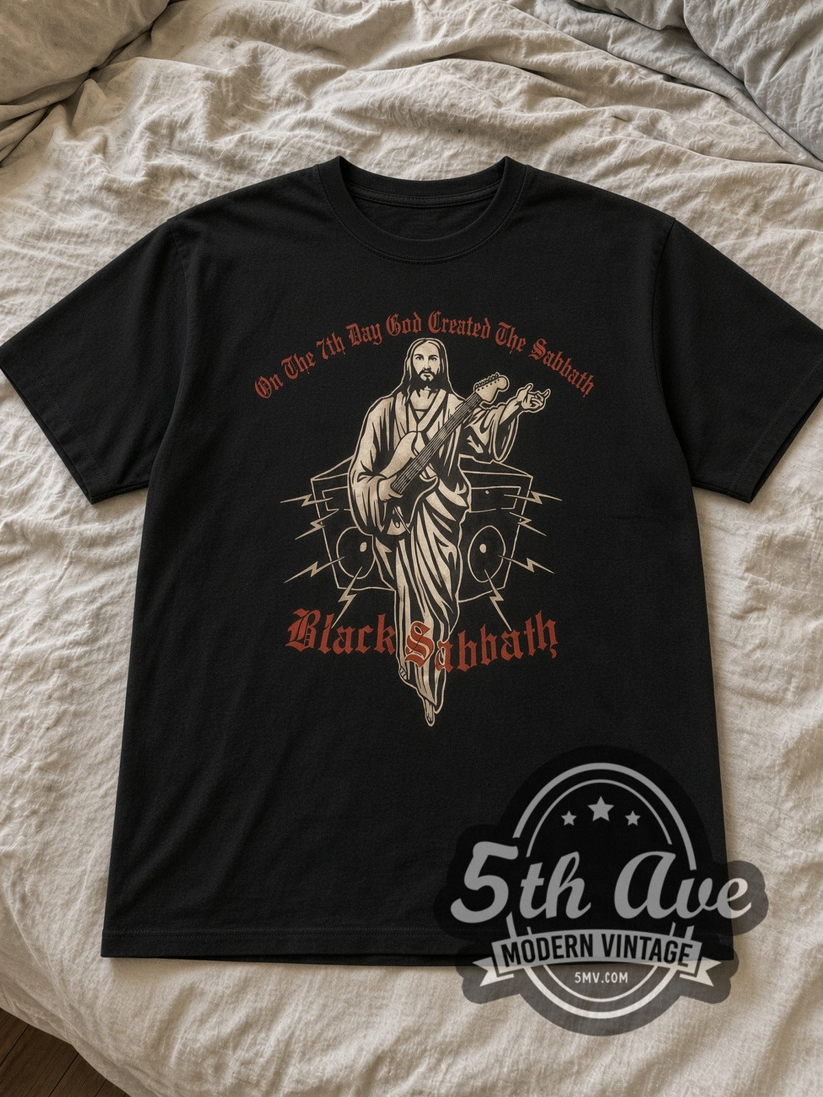 Black Black Sabbath Divine Riffs Vintage Band T-Shirt laid flat on a linen bed