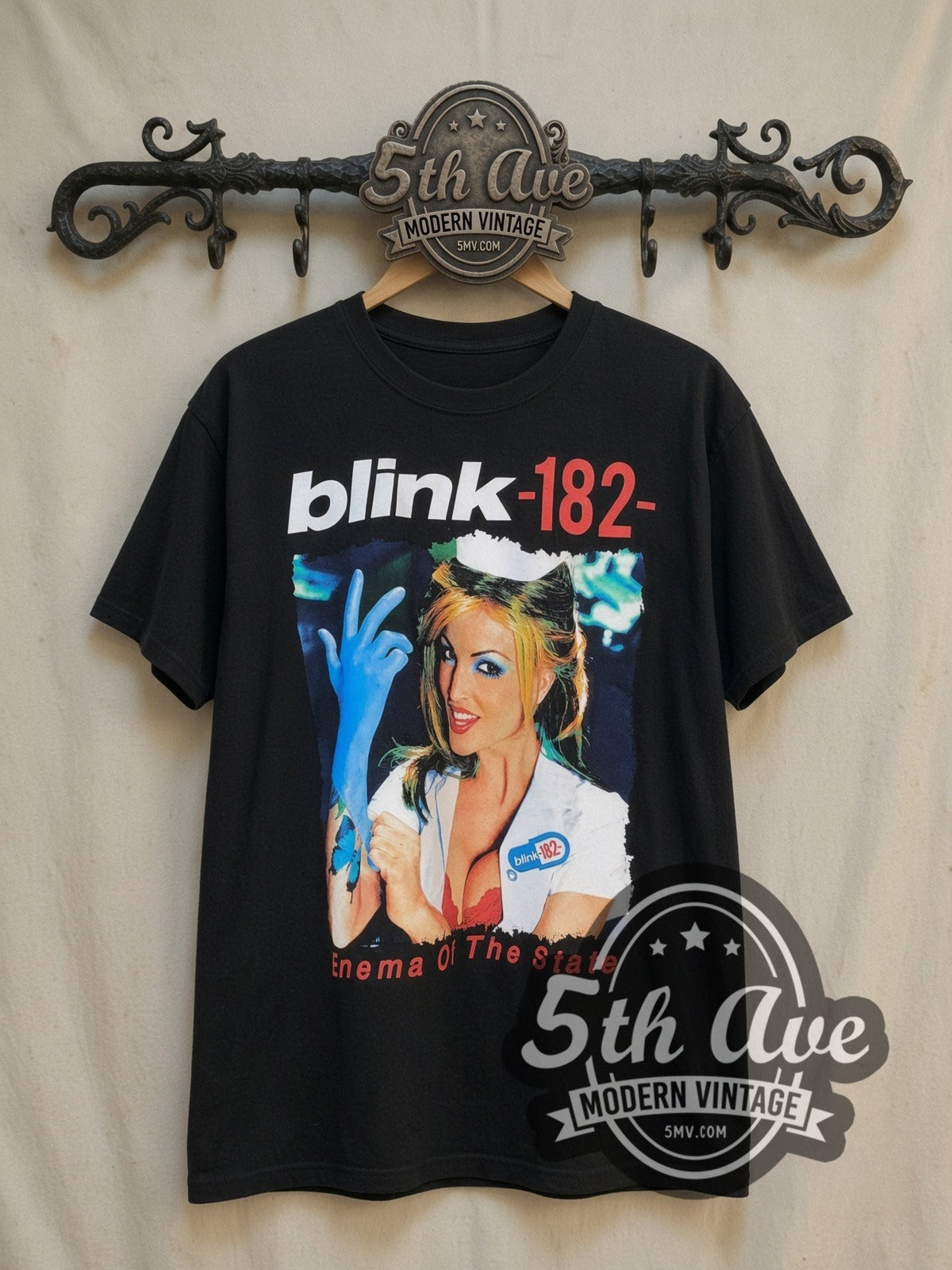 Blink-182 Enema of the State vintage band t-shirt, front view on a display rack