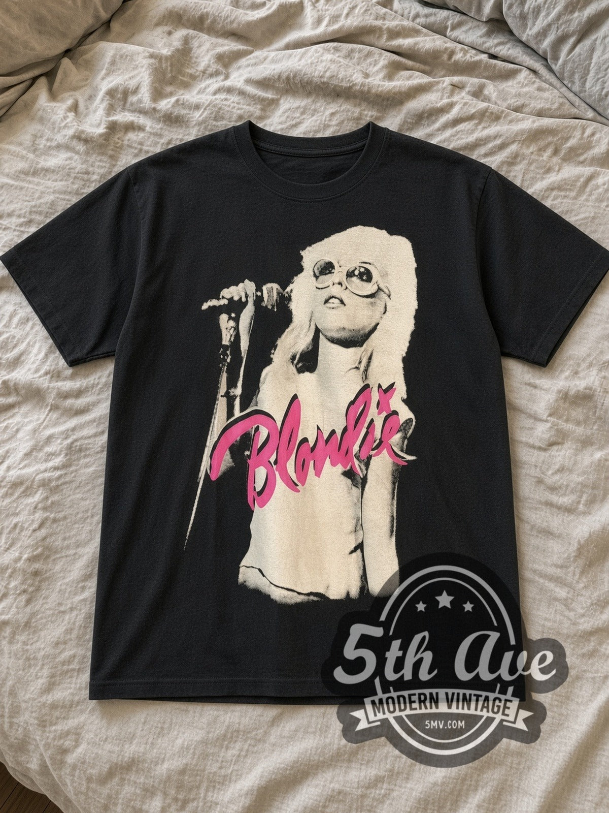 Black Blondie Debbie Harry Microphone Portrait Vintage Band T-Shirt laid flat on a linen bed