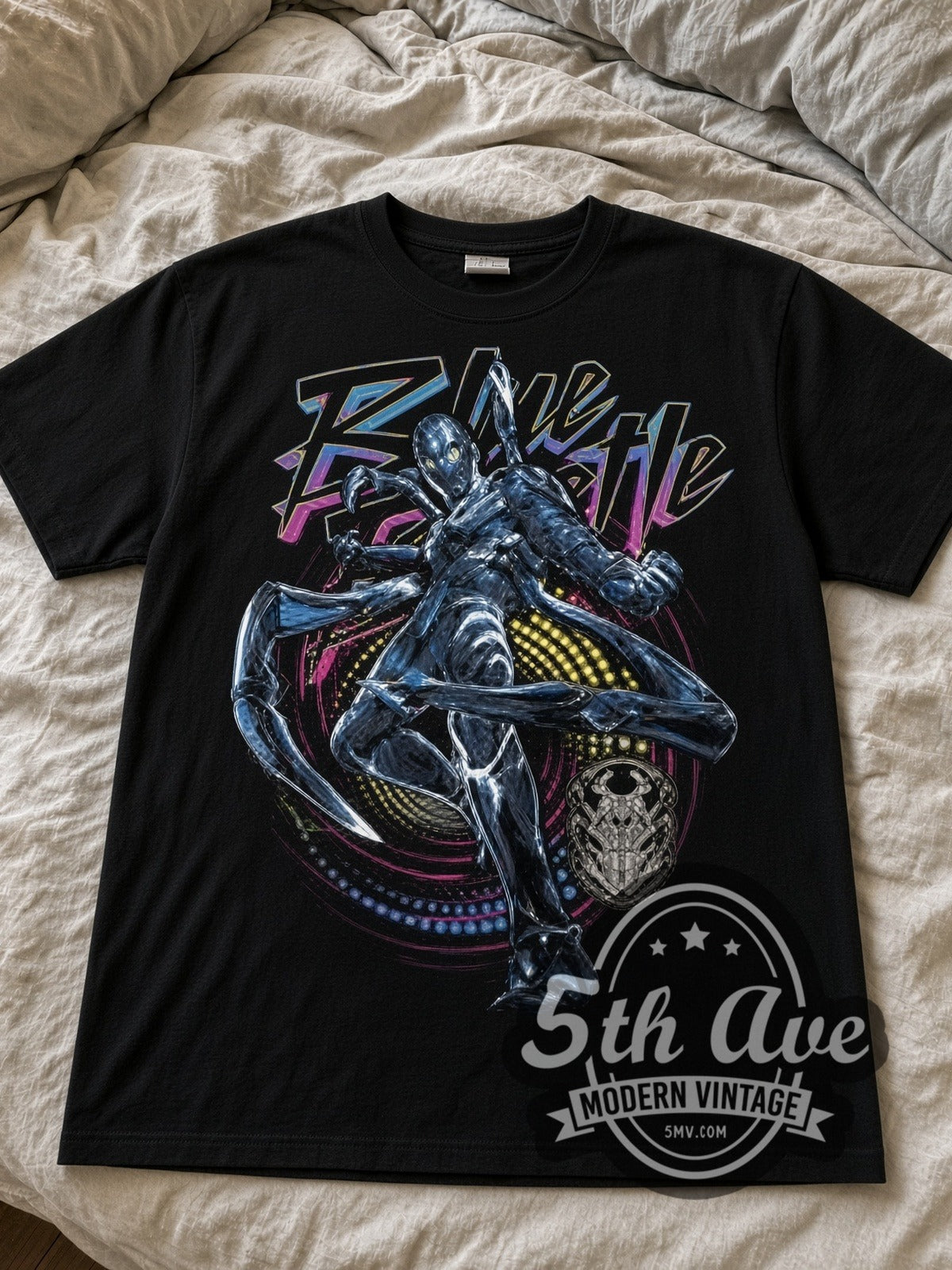 Blue Beetle black graphic tee laid flat on linen bed