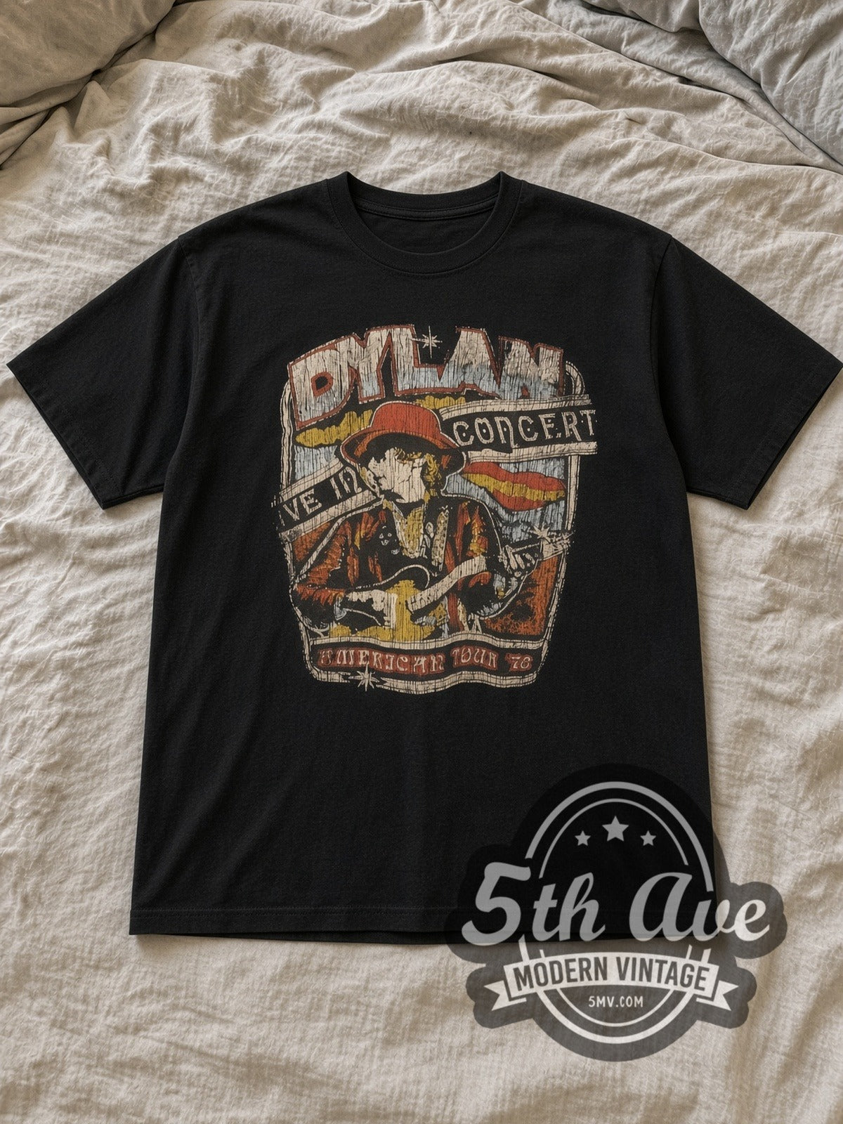 Black Bob Dylan Vintage Band T-Shirt laid flat on a linen bed