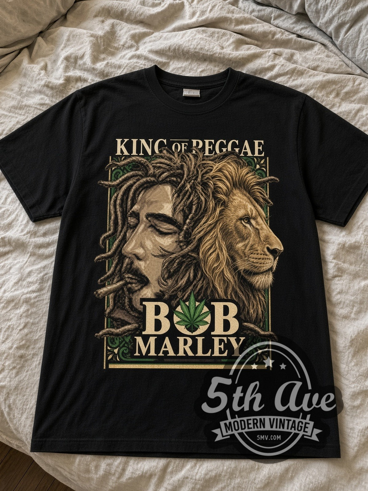 Bob Marley King of Reggae lion black graphic tee laid flat on linen bed