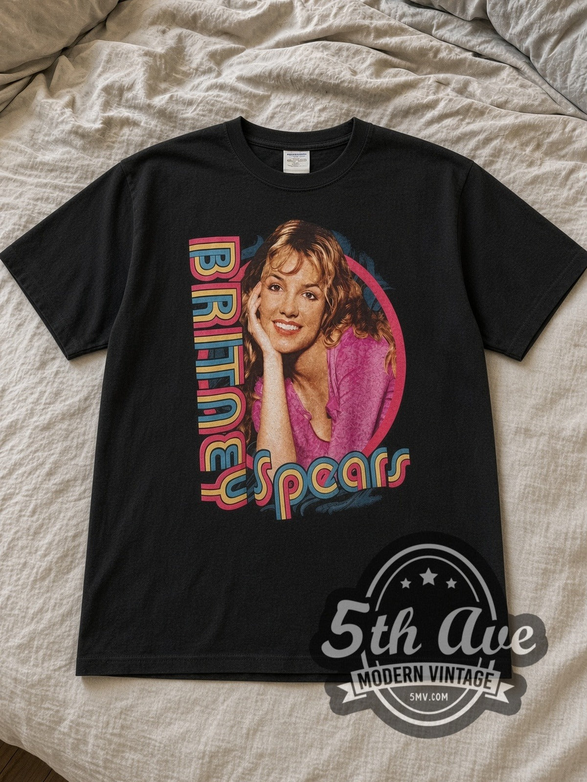Black Britney Baby One More Time Vintage Band T-Shirt laid flat on a linen bed