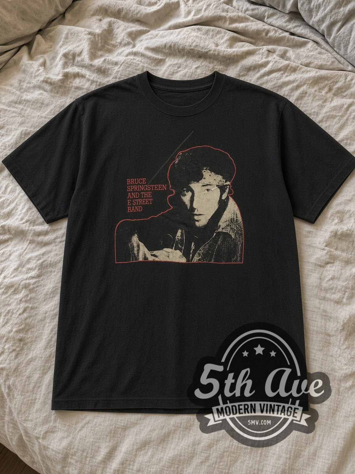 Black Bruce Springsteen Vintage Band T-Shirt laid flat on a linen bed