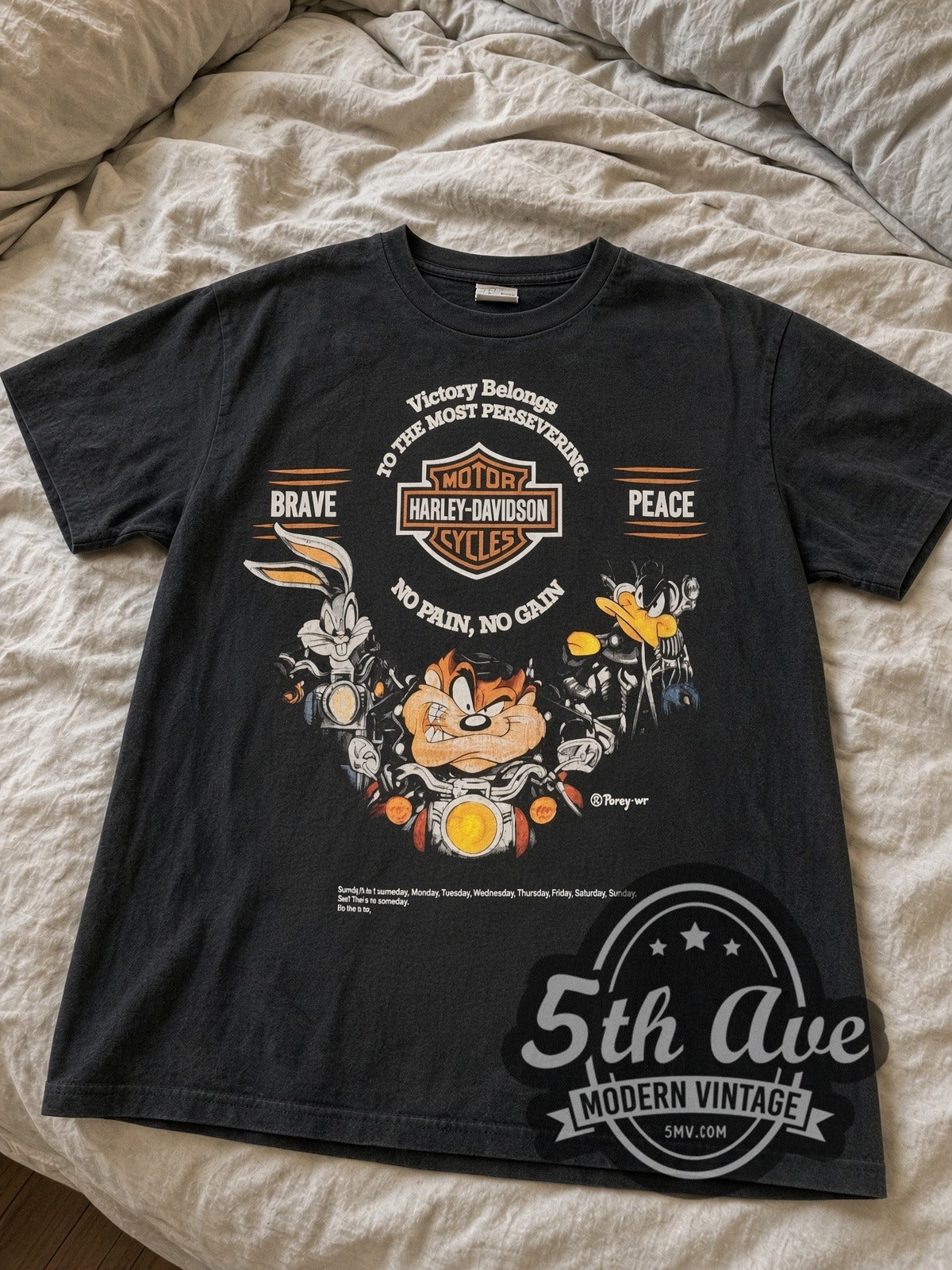 Harley-Davidson x Looney Tunes Victory Belongs To The Most Persevering vintage Harley tee laid flat