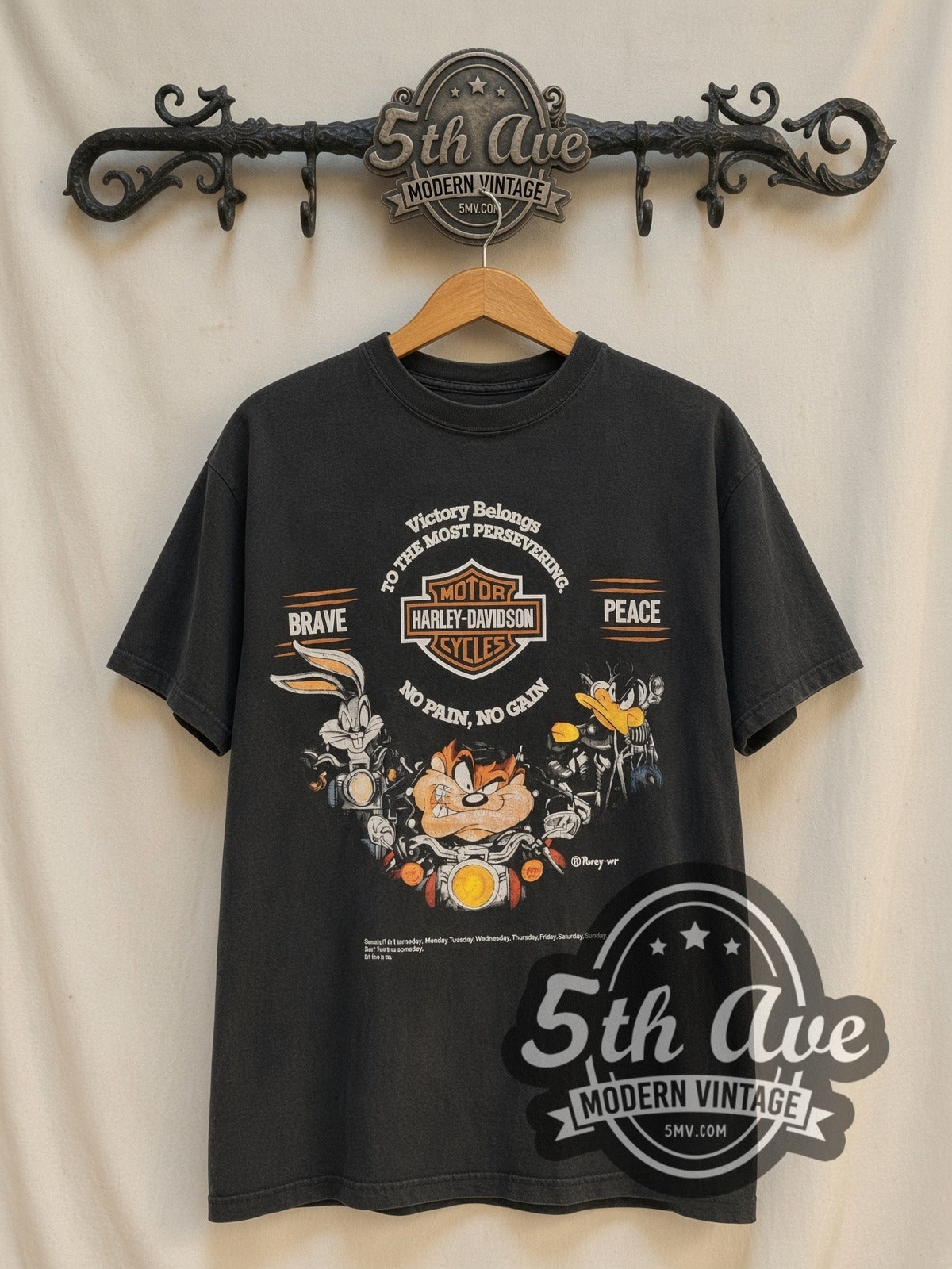 Harley-Davidson x Looney Tunes Victory Belongs To The Most Persevering vintage Harley t-shirt, front view on a display rack