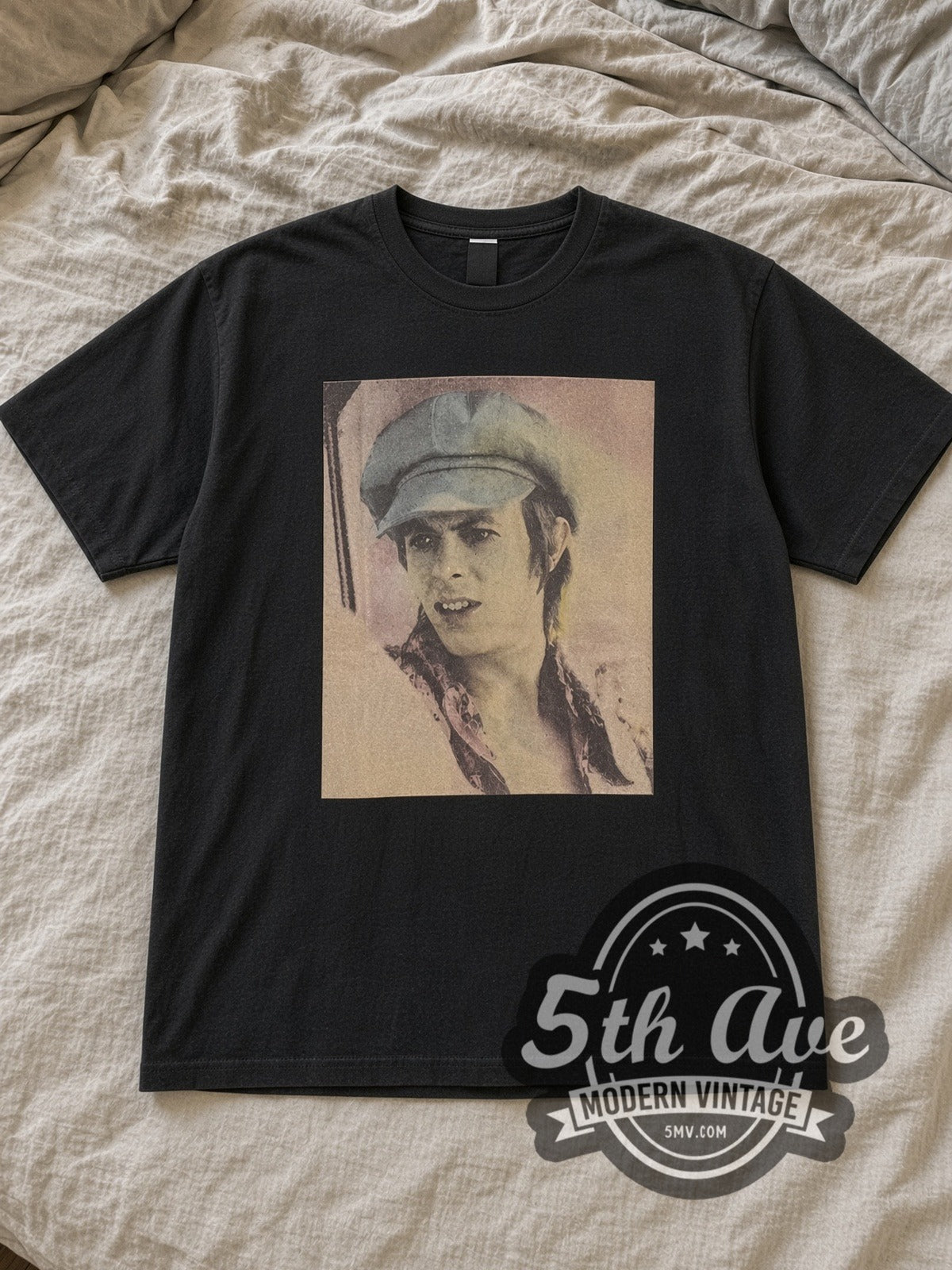 Black David Bowie Blue 70s Hat Portrait Vintage Band T-Shirt laid flat on a linen bed