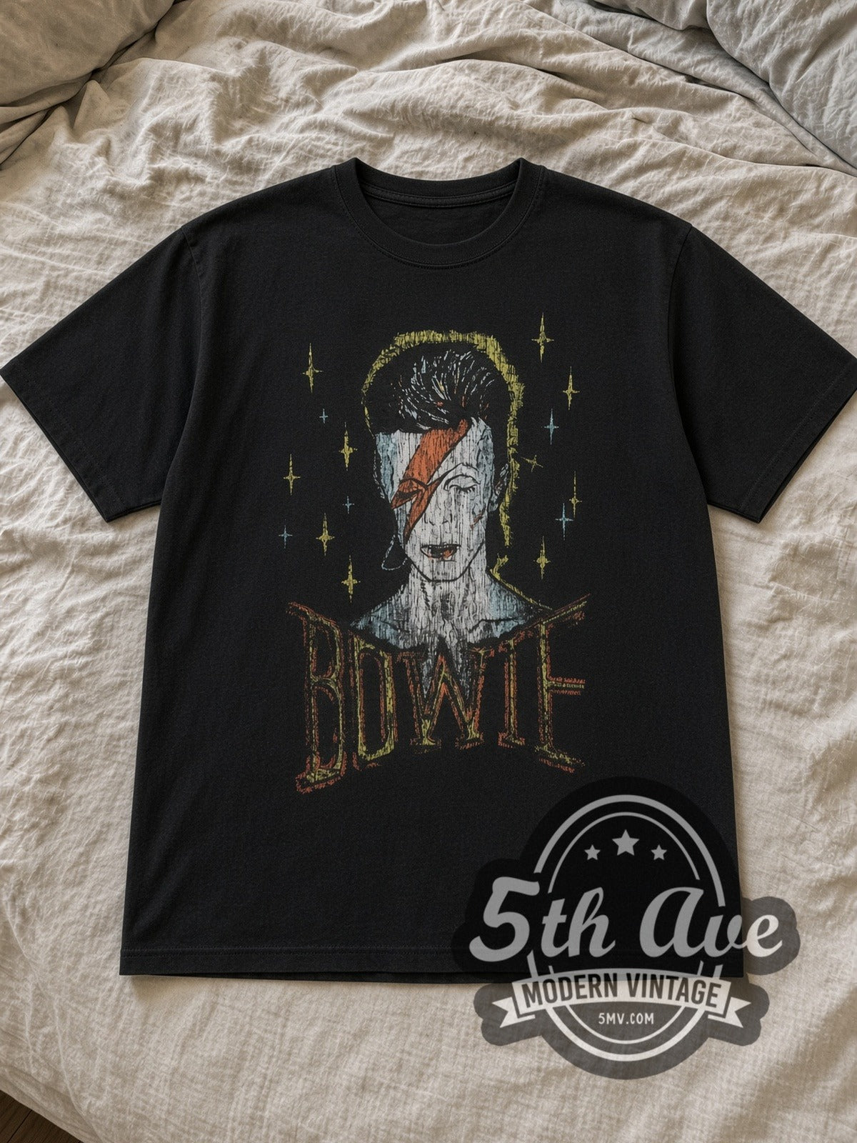 Black David Bowie 1976 World Tour Vintage Band T-Shirt laid flat on a linen bed