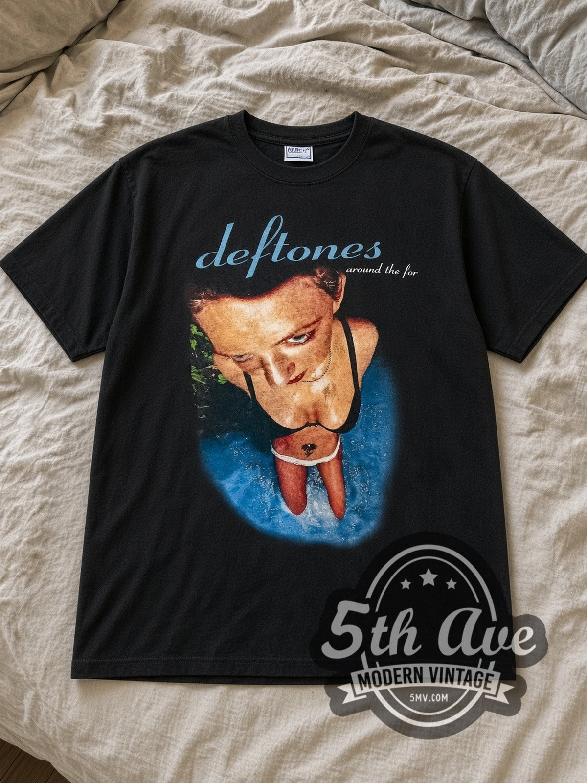 Black Deftones "Around The Fur" Vintage Band T-Shirt laid flat on a linen bed