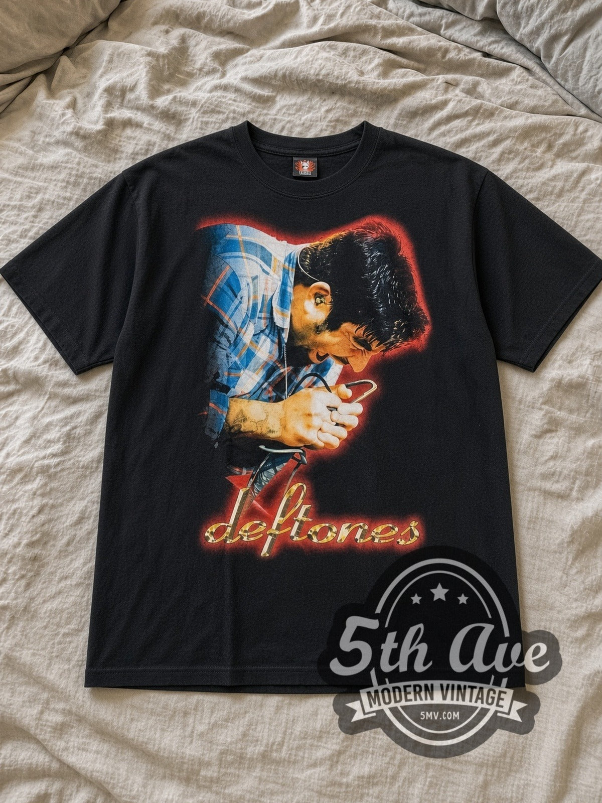 Black Deftones Chino Moreno Vintage Band T-Shirt laid flat on a linen bed