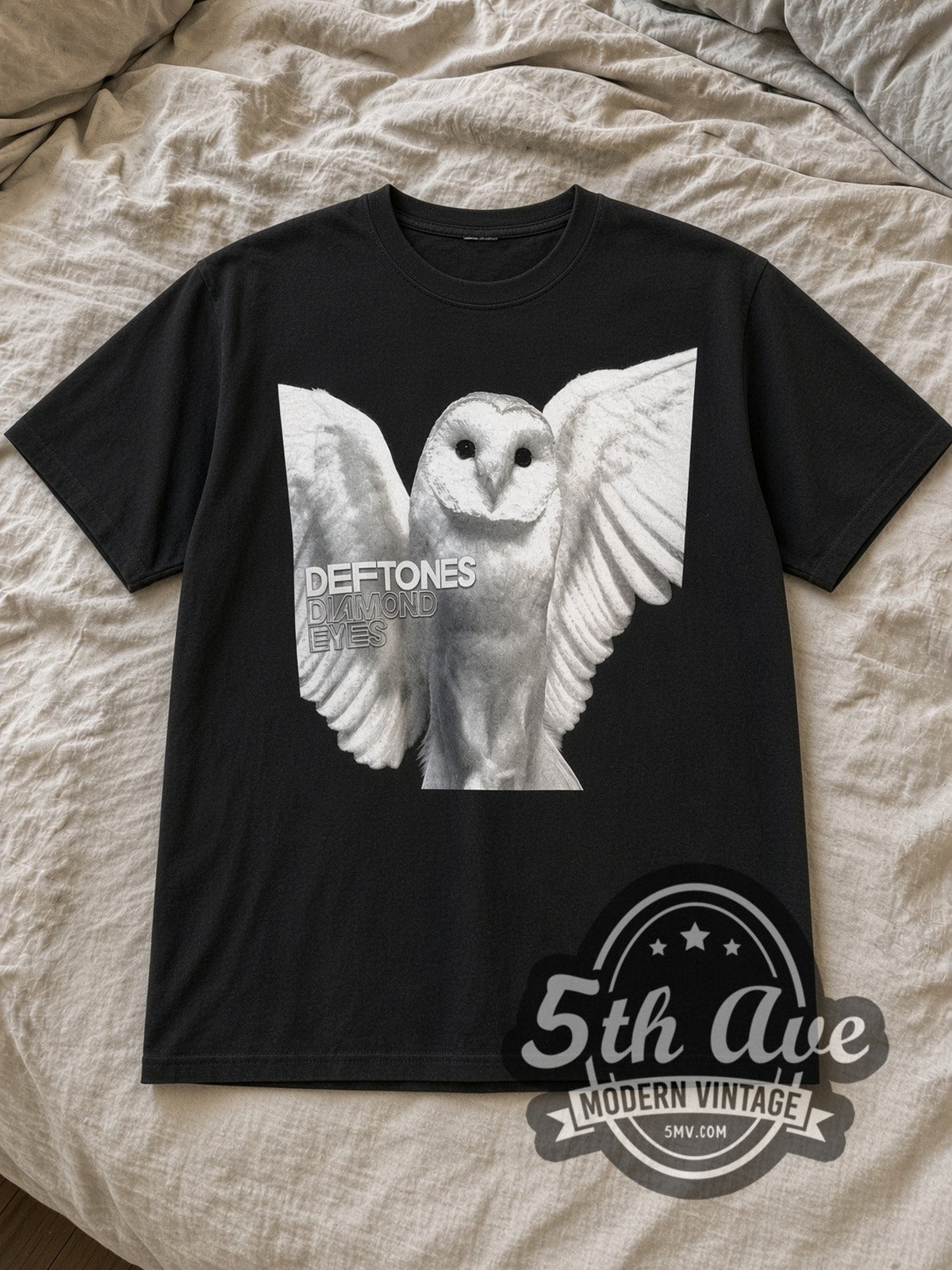 Black Deftones Vintage Band T-Shirt laid flat on a linen bed