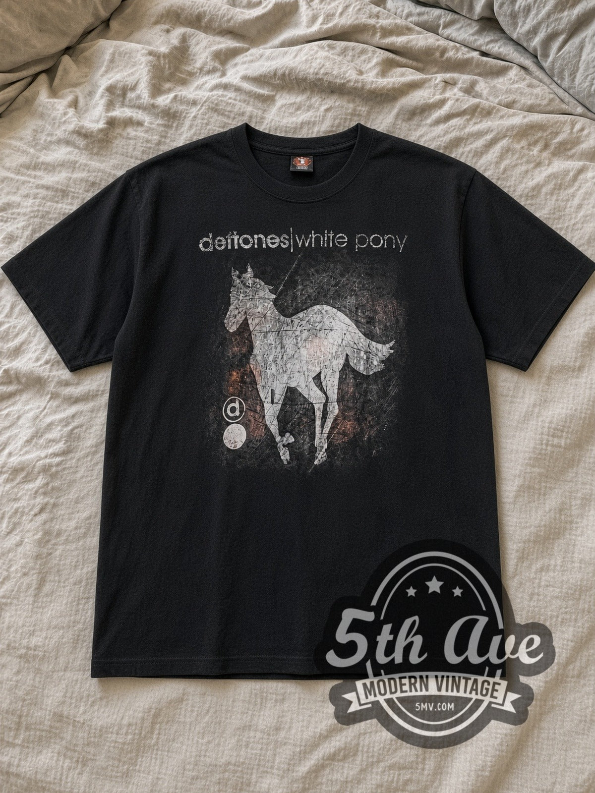 Black Deftones White Pony Vintage Band T-Shirt laid flat on a linen bed