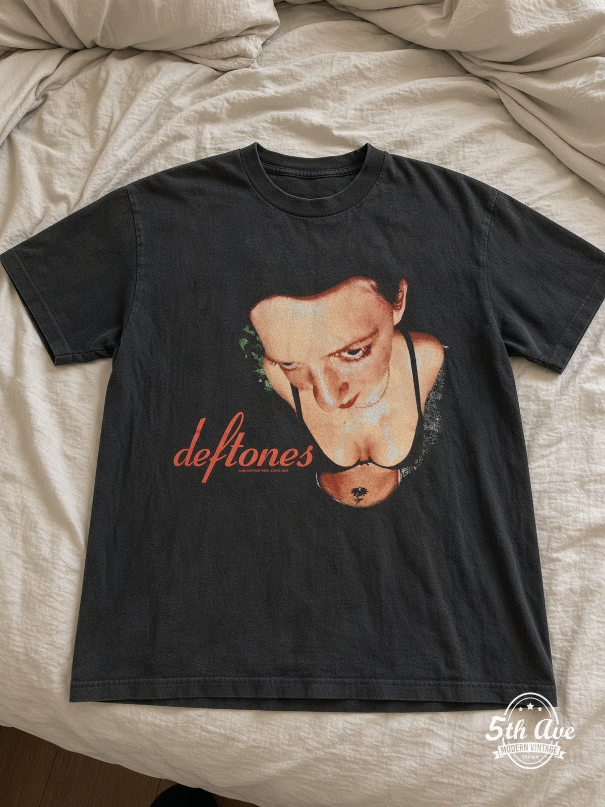 Deftones Woman Face Red Script vintage tee laid on bed