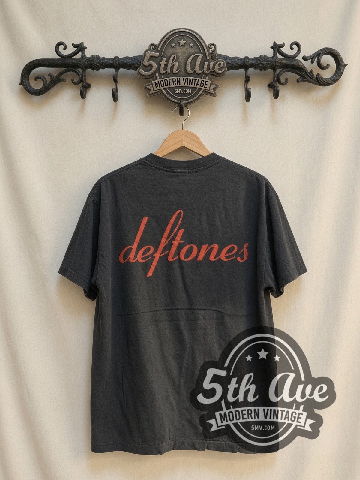 Deftones Woman Face Red Script vintage band t-shirt, back view on a display rack