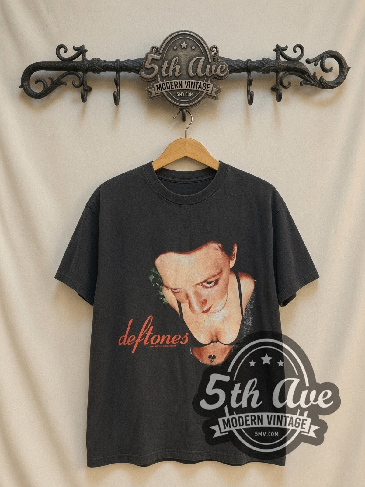 Deftones Woman Face Red Script vintage band t-shirt, front view on a display rack