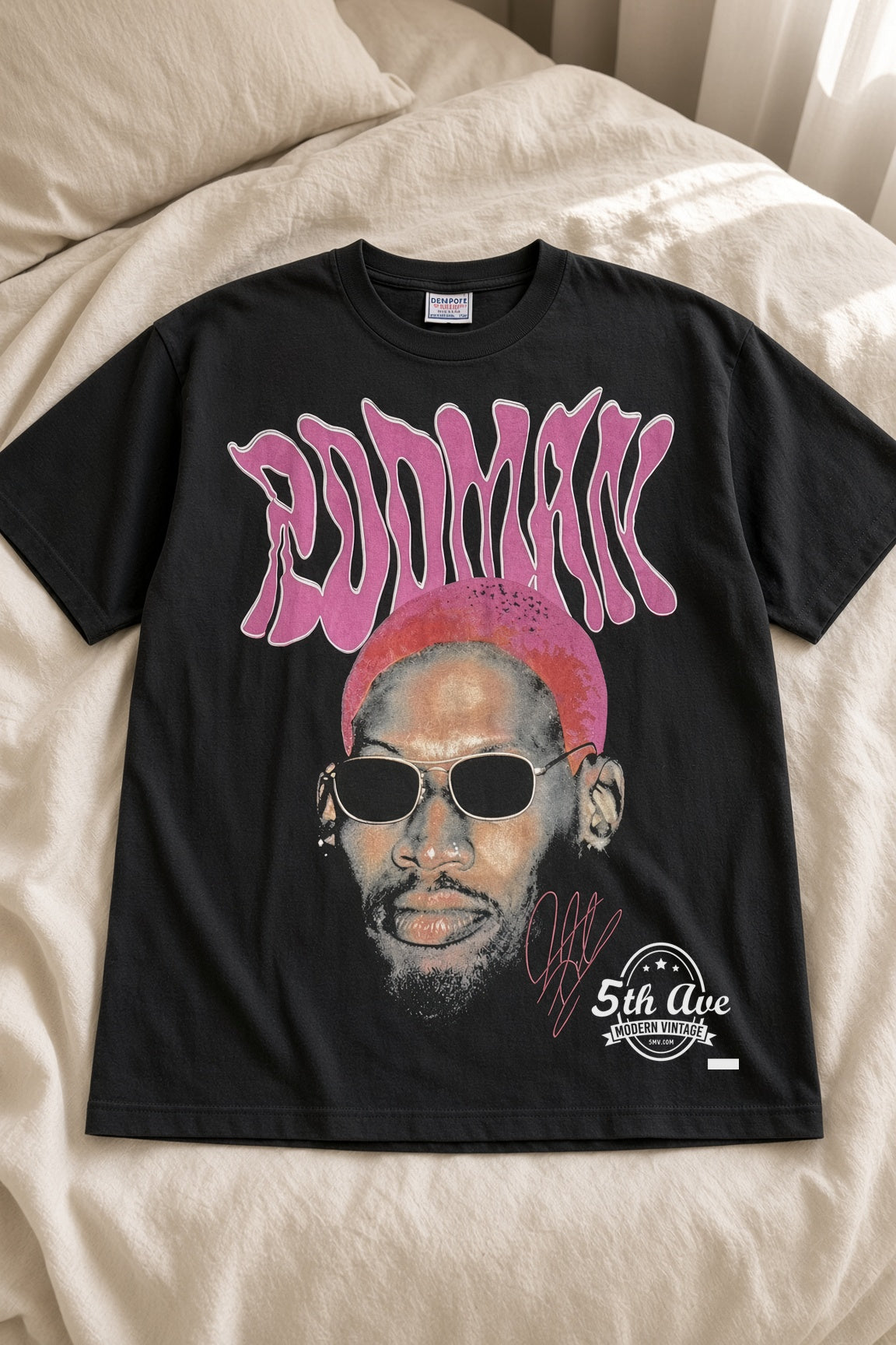 Dennis Rodman Pink Hair The Worm 91 vintage t-shirt laid on bed