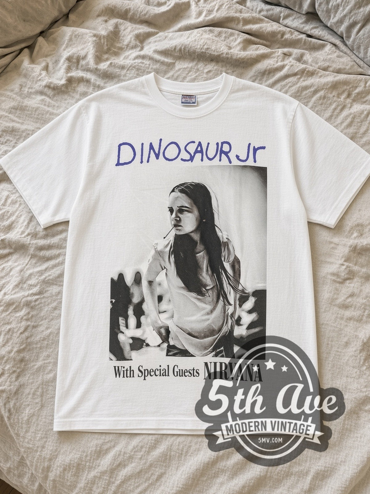 White Dinosaur Jr. 'With Special Guests NIRVANA' Vintage Band T-Shirt laid flat on a linen bed