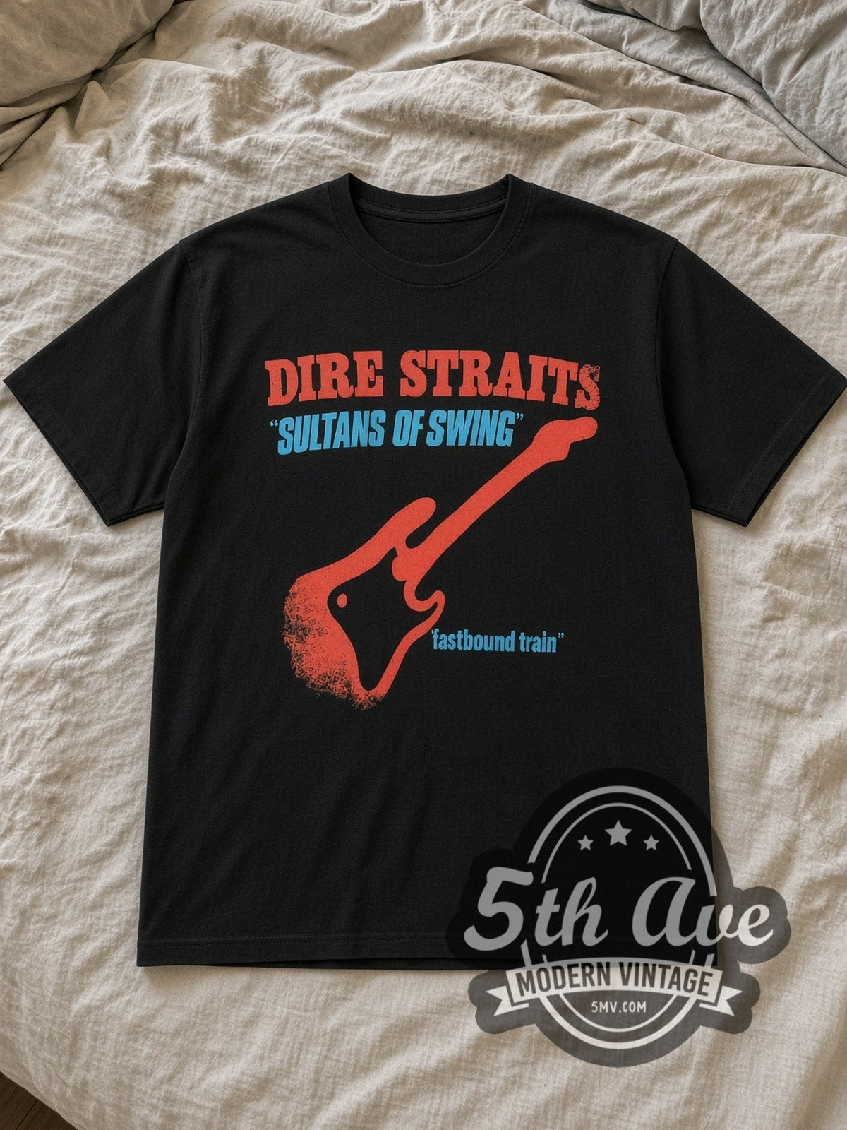Black Dire Straits Sultans of Swing Vintage Band T-Shirt laid flat on a linen bed