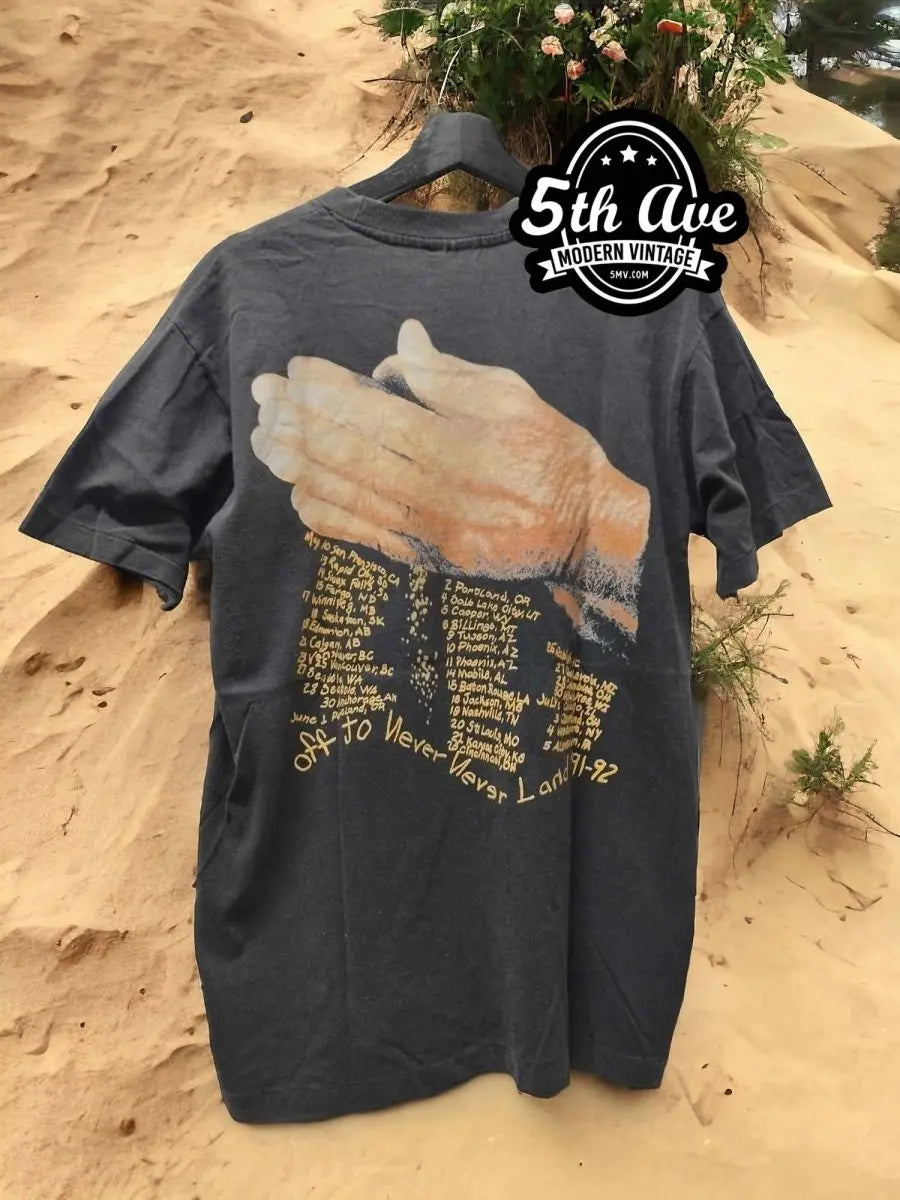 Distressed Metallica 'Enter Sandman' Tour Tee vintage t-shirt laid on bed