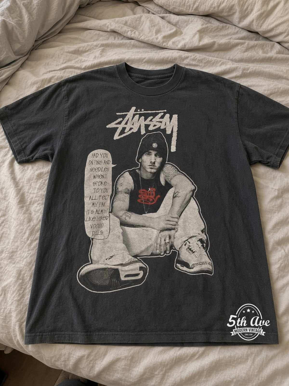 Eminem Stussy Pins and Needles vintage band tee laid on bed