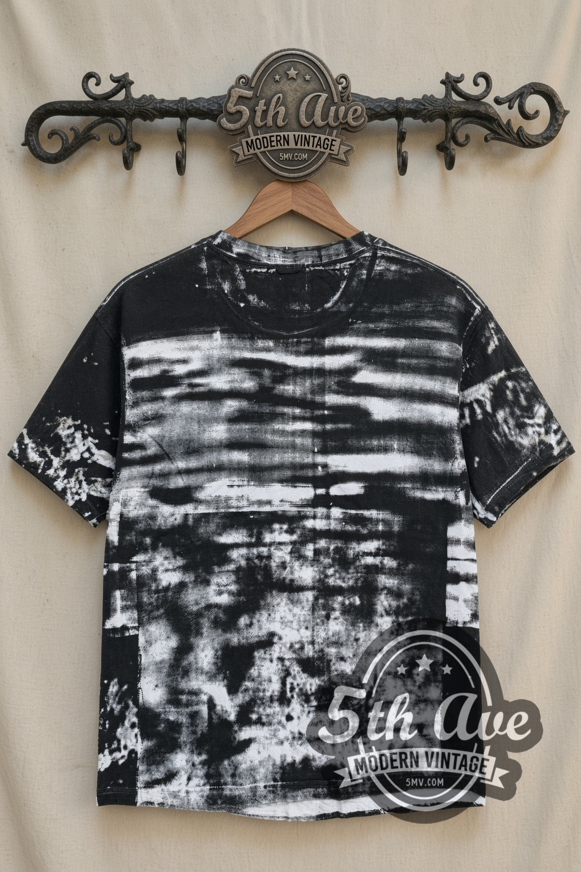 Fire Marshal Bill In Living Color all-over-print t-shirt, back view on a display rack with black-and-white smeared all-over print