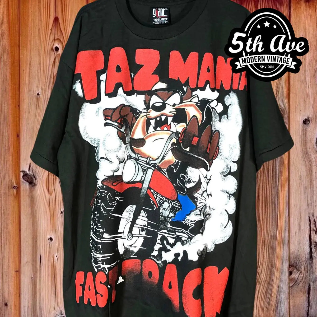 Looney Tunes Taz-Mania Fast Track all-over-print graphic tee, front view on a display rack
