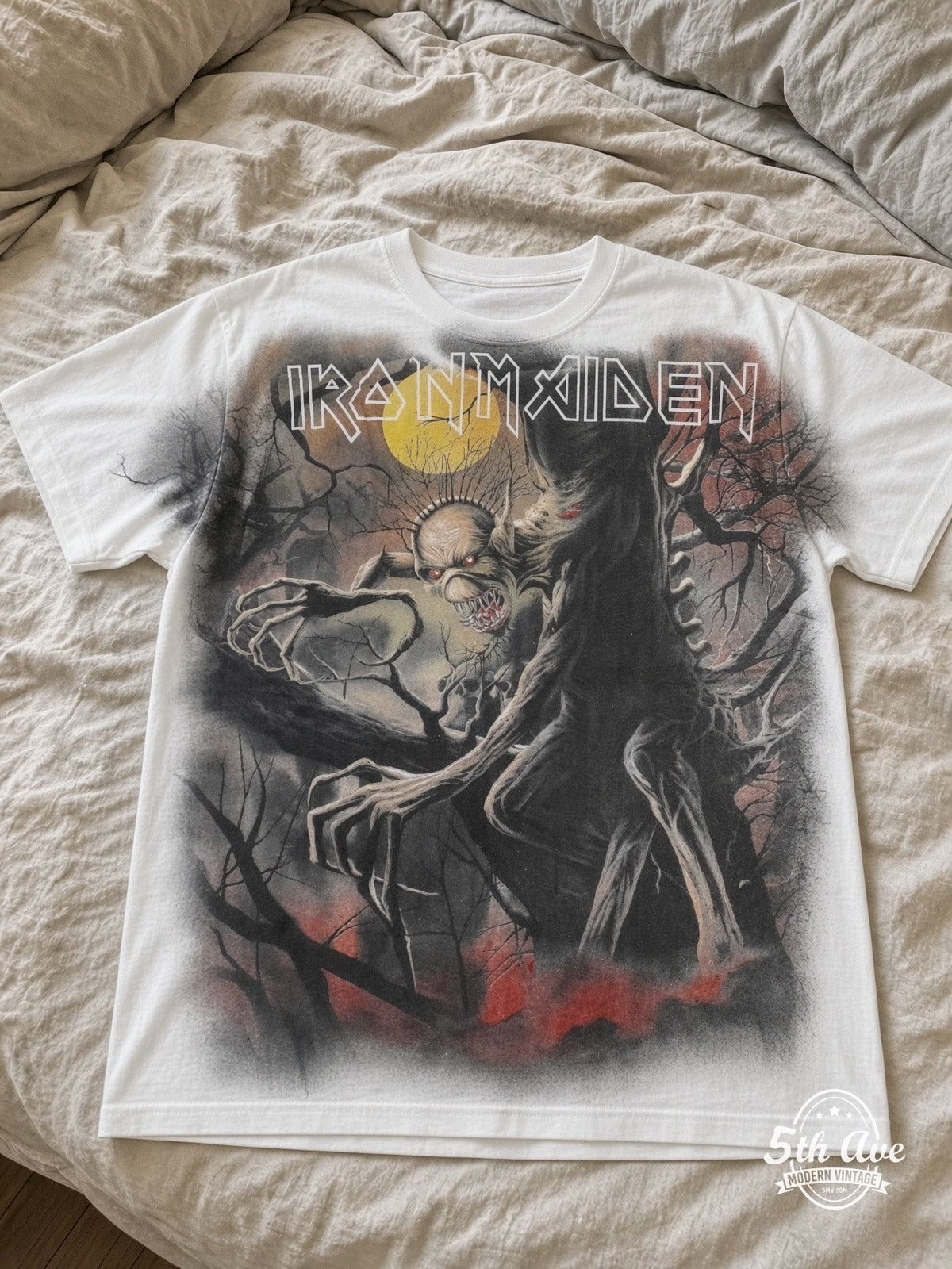 Iron Maiden Fear of the Dark Eddie tree moon AOP white vintage band t-shirt laid on bed