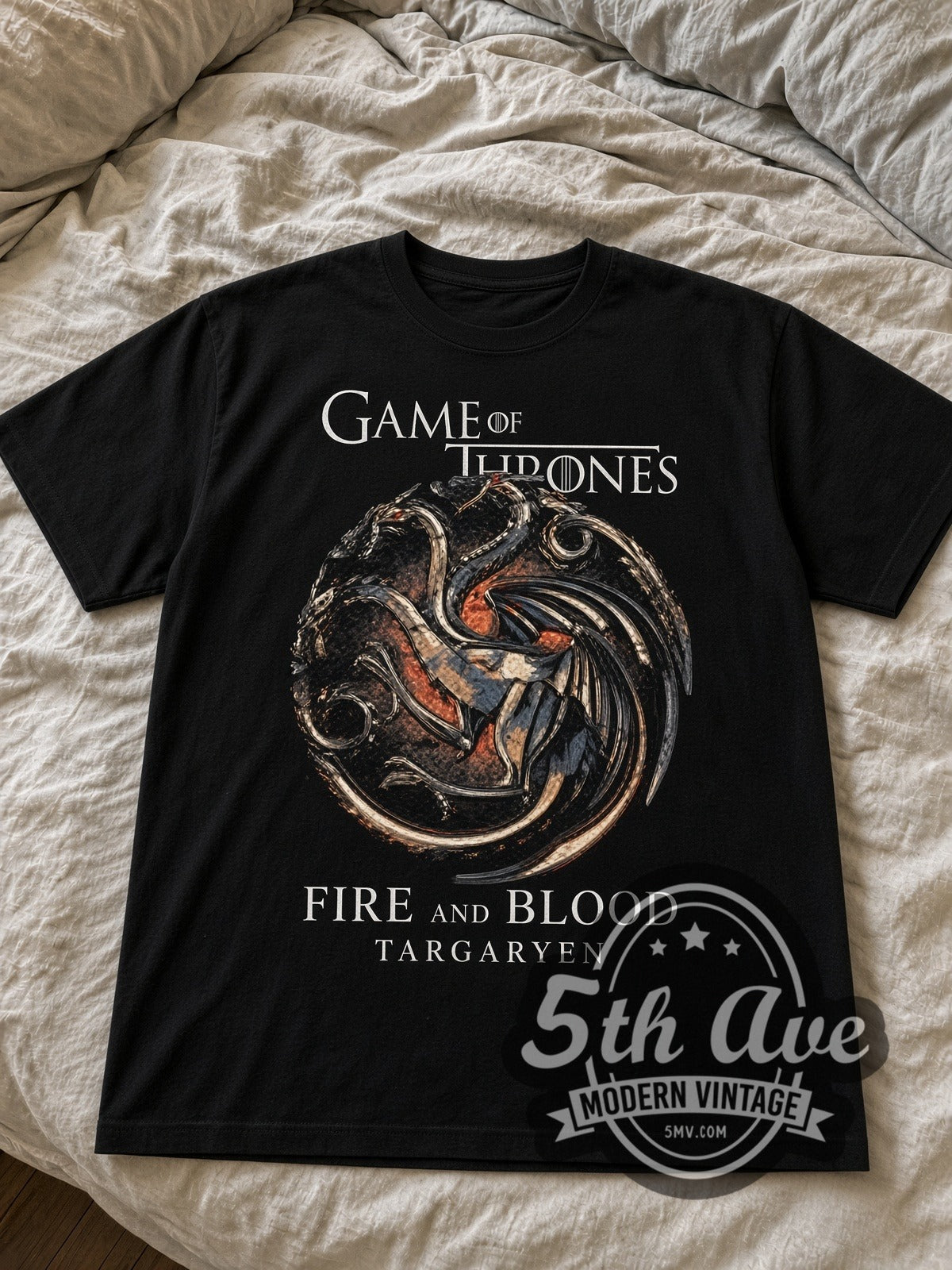 Game of Thrones House Targaryen Fire and Blood black graphic tee laid flat on linen bed