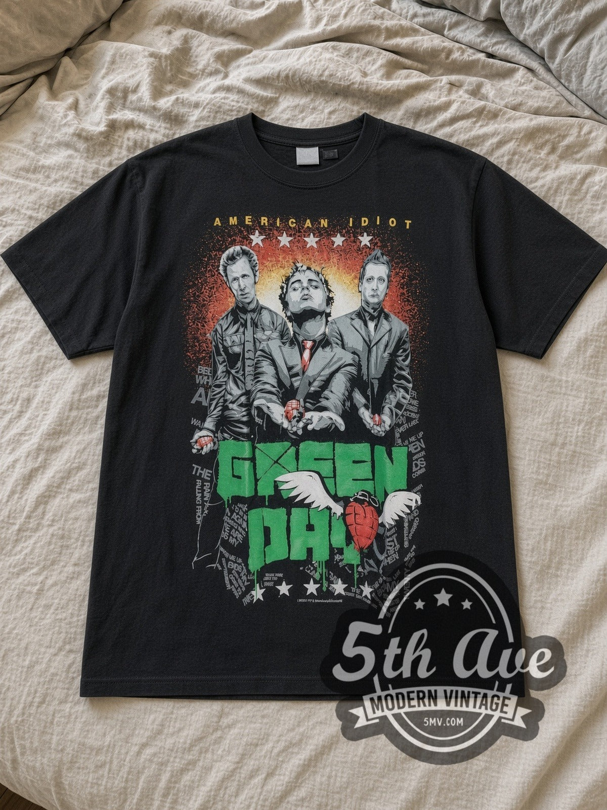 Black Green Day American Idiot Band Trio Heart Grenade Vintage Band T-Shirt laid flat on a linen bed
