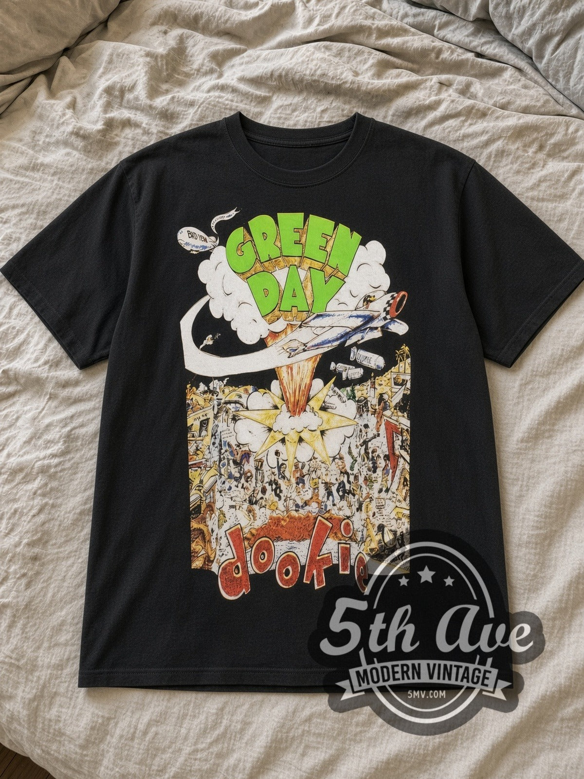 Black Green Day Dookie Album Cover Bomber Vintage Band T-Shirt laid flat on a linen bed