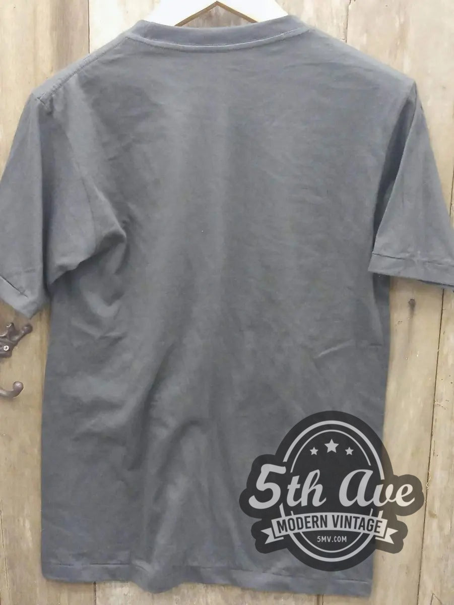 Guns N' Roses – Skull and Roses Banner vintage band t-shirt hanging on a hanger