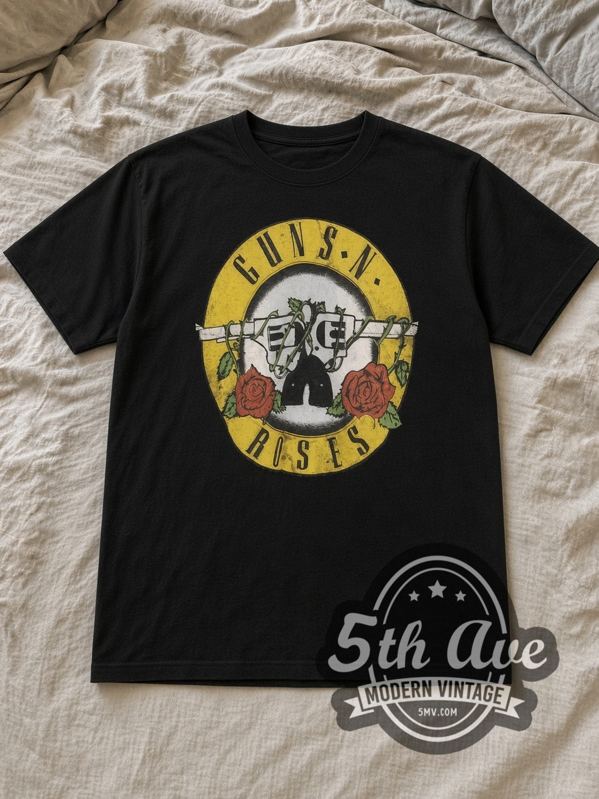Black Guns N' Roses Bullet Circle Logo Vintage Band T-Shirt laid flat on a linen bed