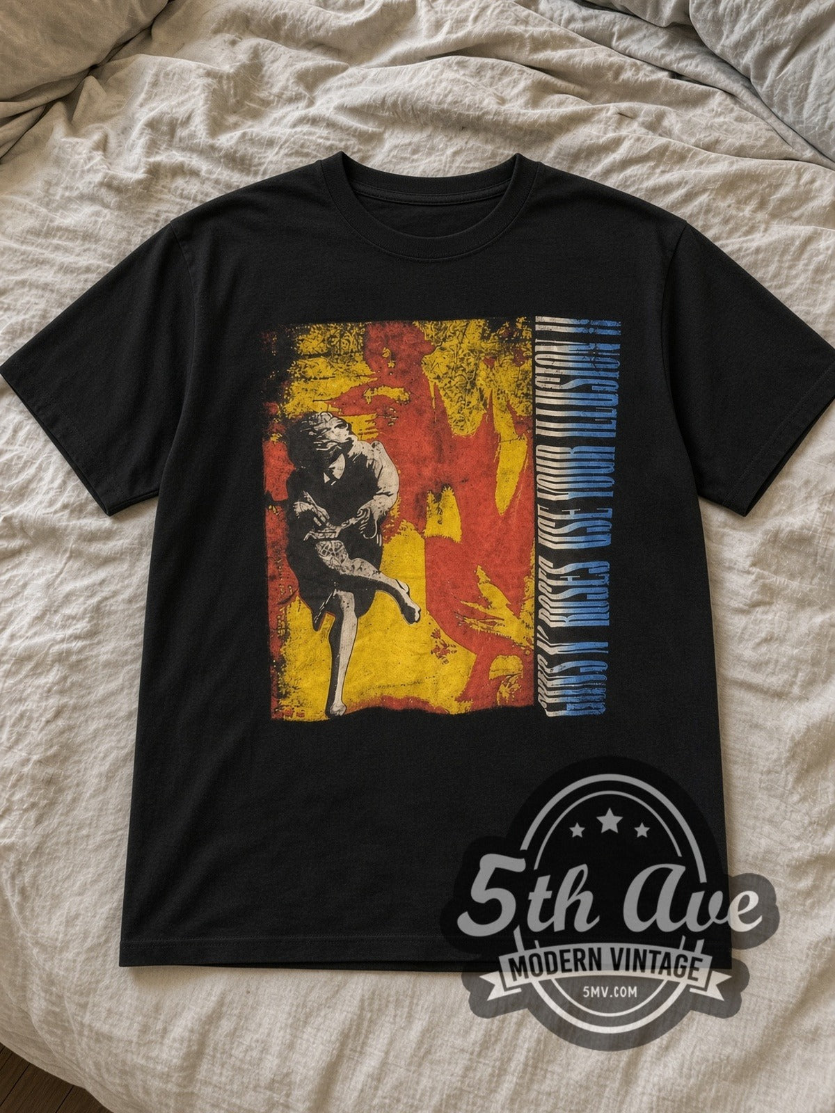 Black Guns N' Roses Use Your Illusion Vintage Band T-Shirt laid flat on a linen bed