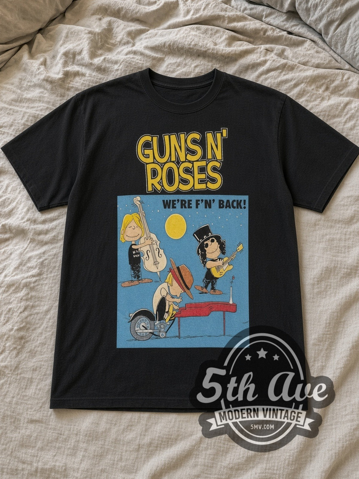 Black Peanuts Guns N' Roses x Snoopy WE'RE F'N BACK! Vintage Cartoon T-Shirt laid flat on a linen bed