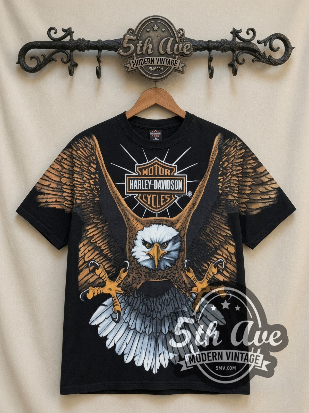 Harley-Davidson Bald Eagle Bar Shield all-over-print vintage Harley tee in black, front view on a display rack