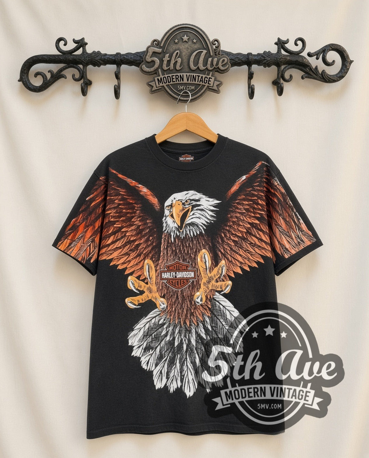 Harley-Davidson Eagle all-over-print vintage Harley tee in black, front view on a display rack