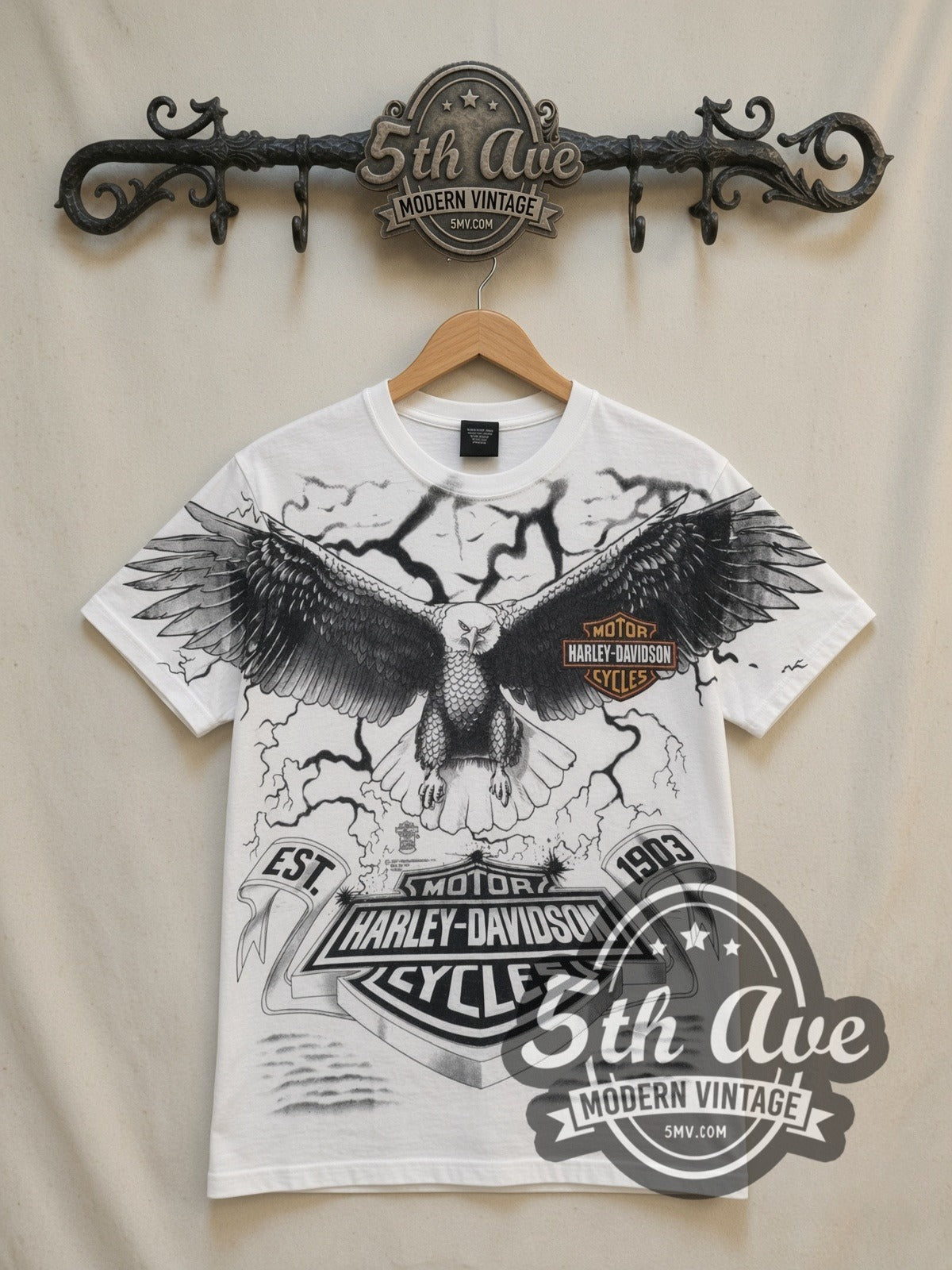 Harley-Davidson Eagle Lightning EST 1903 all-over-print vintage Harley tee in white, front view on a display rack