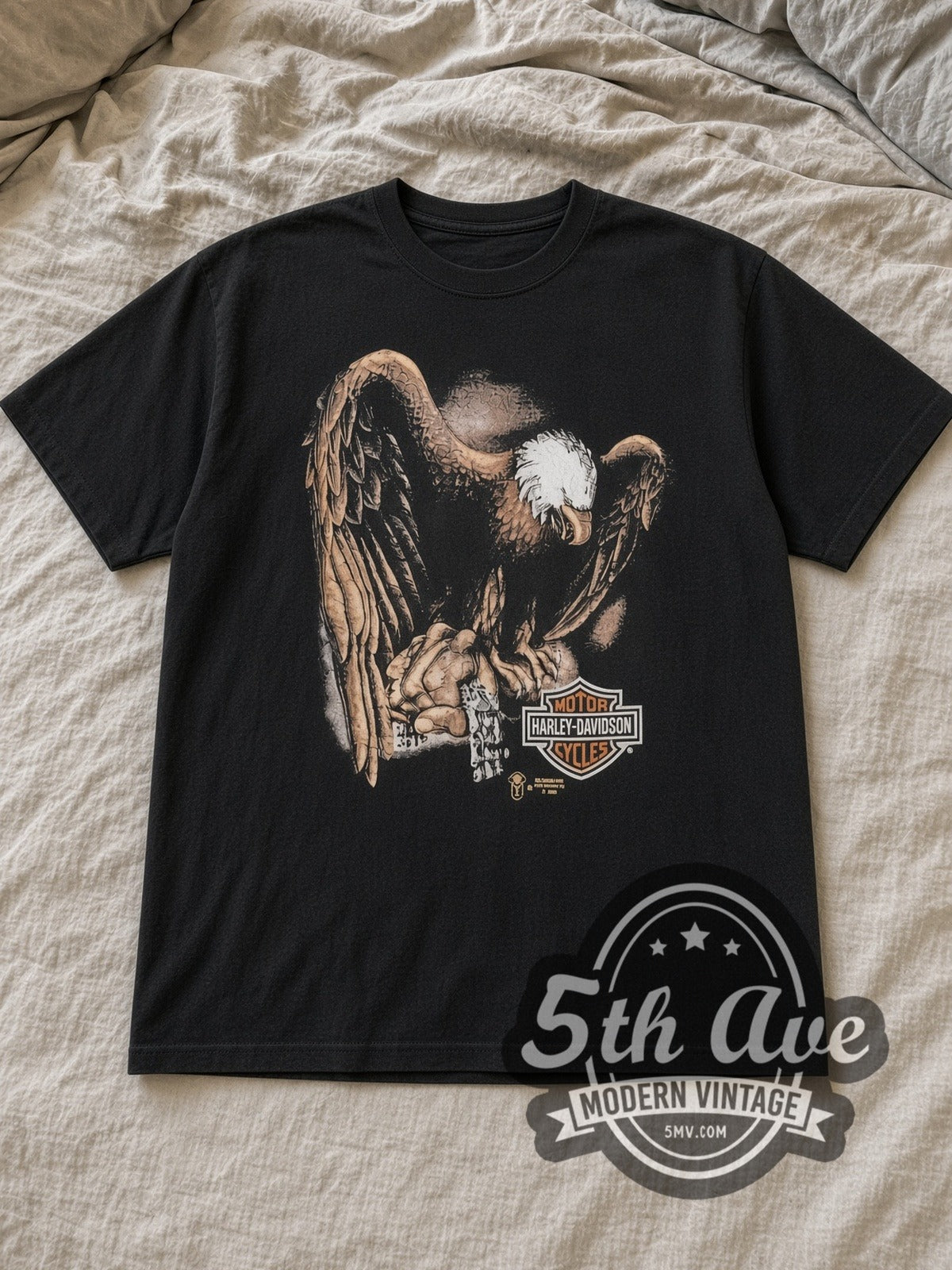 Black Harley Davidson Kenosha Vintage Harley-Davidson T-Shirt laid flat on a linen bed