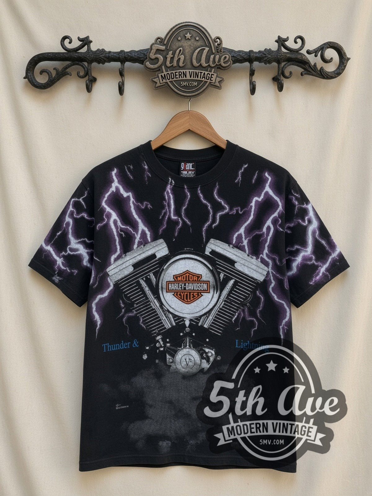 Harley-Davidson Thunder Lightning Engine all-over-print vintage Harley tee in black, front view on a display rack