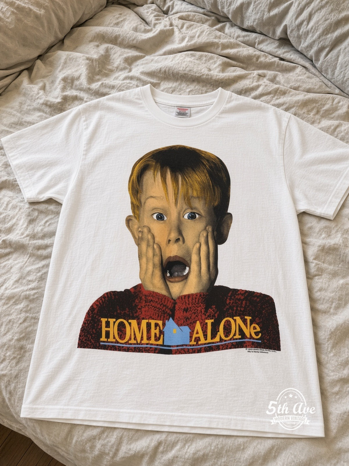 Home Alone Pepsi Kevin Scream vintage tee laid on bed