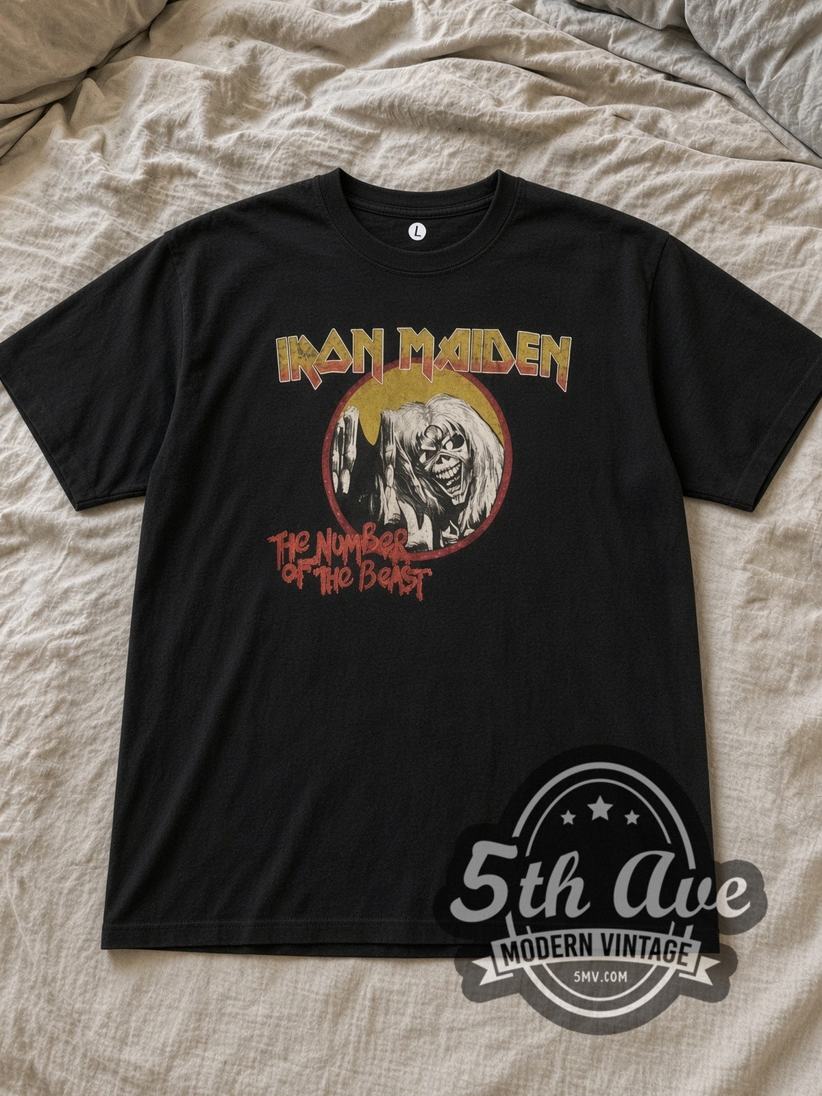 Black Iron Maiden The Number of the Beast Circle Logo Vintage Band T-Shirt laid flat on a linen bed