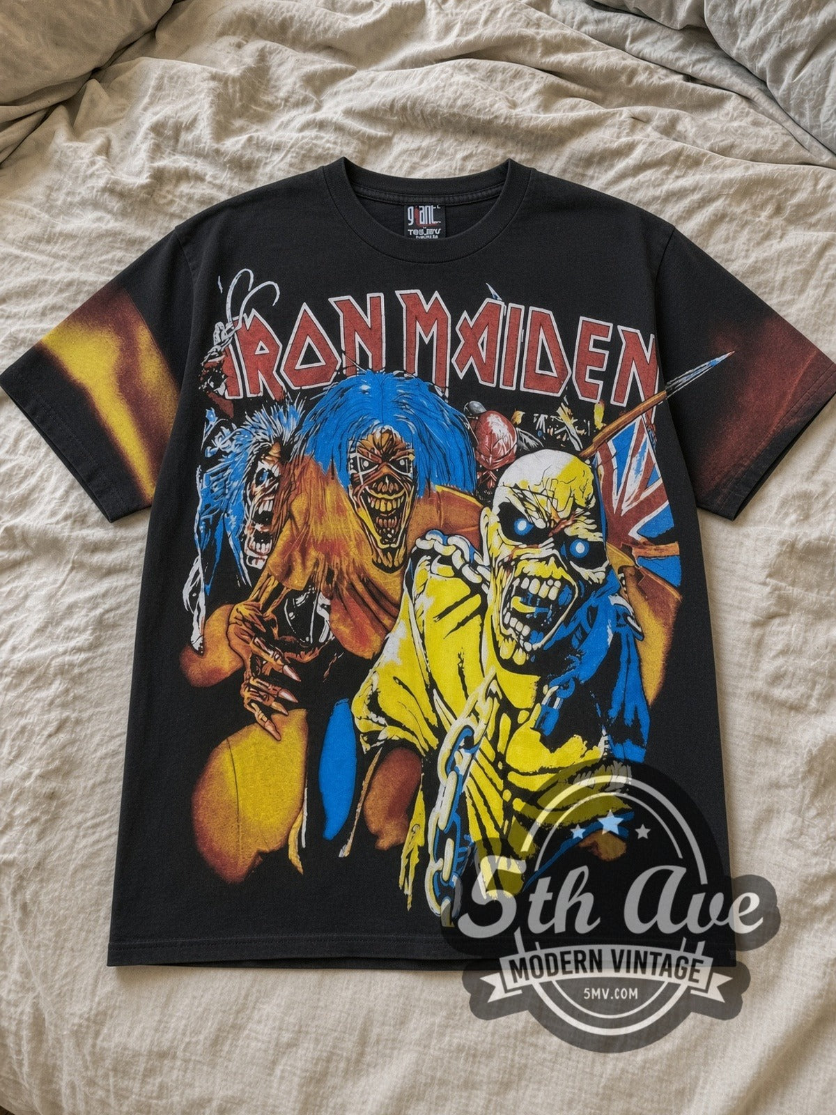 Black Iron Maiden Iron Maiden Artwork All Over Print Vintage Band T-Shirt laid flat on a linen bed