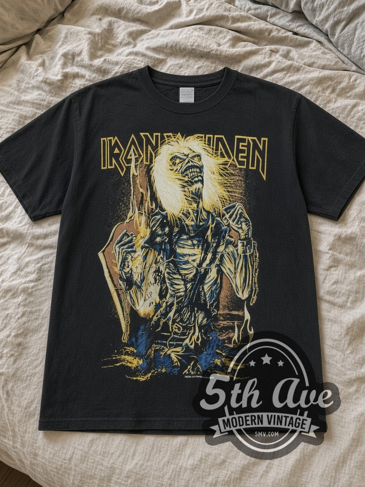 Black Iron Maiden Chained Eddie RIP Tombstone Vintage Band T-Shirt laid flat on a linen bed