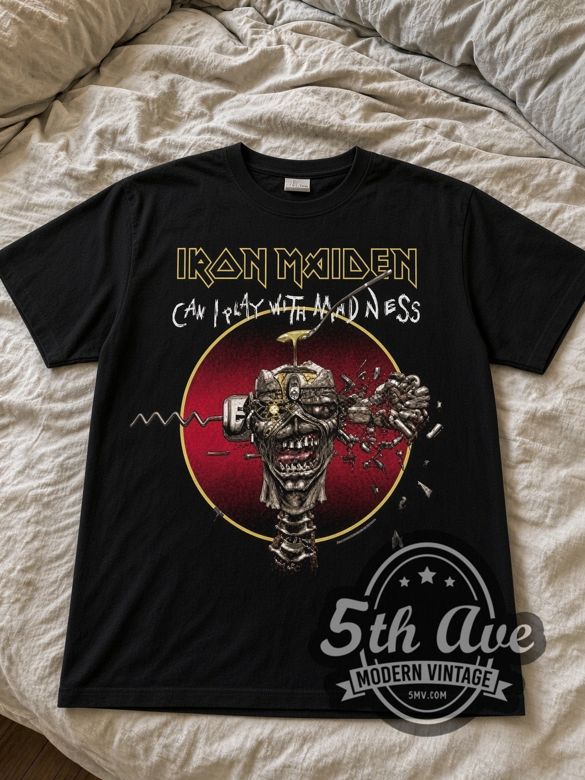 Iron Maiden Can I Play with Madness Eddie black graphic tee laid flat on linen bed