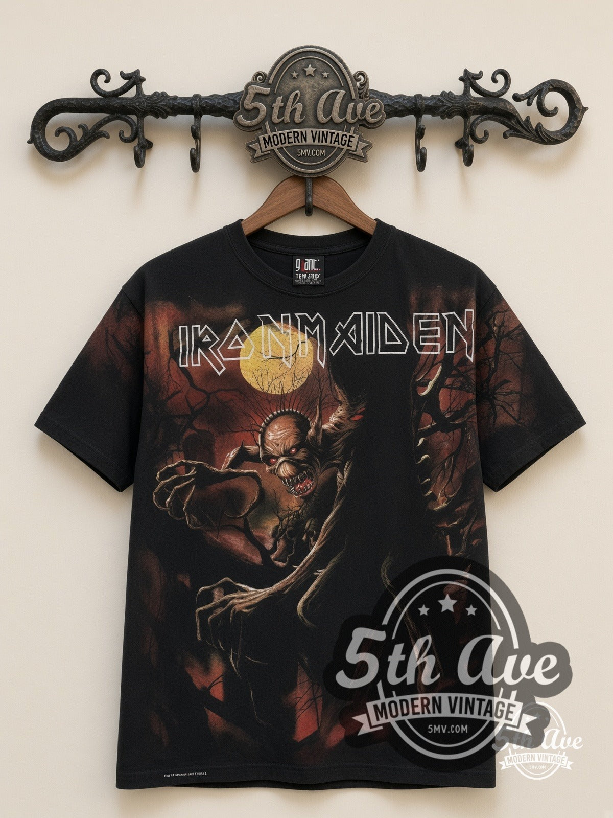 Iron Maiden Fear of the Dark Tree Eddie all-over-print vintage band t-shirt in black, front view on a display rack