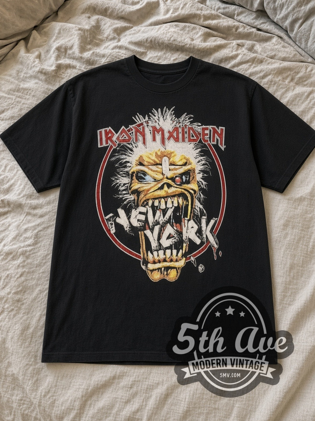 Black Iron Maiden Seventh Tour of a Seventh Tour 1988 Vintage Band T-Shirt laid flat on a linen bed