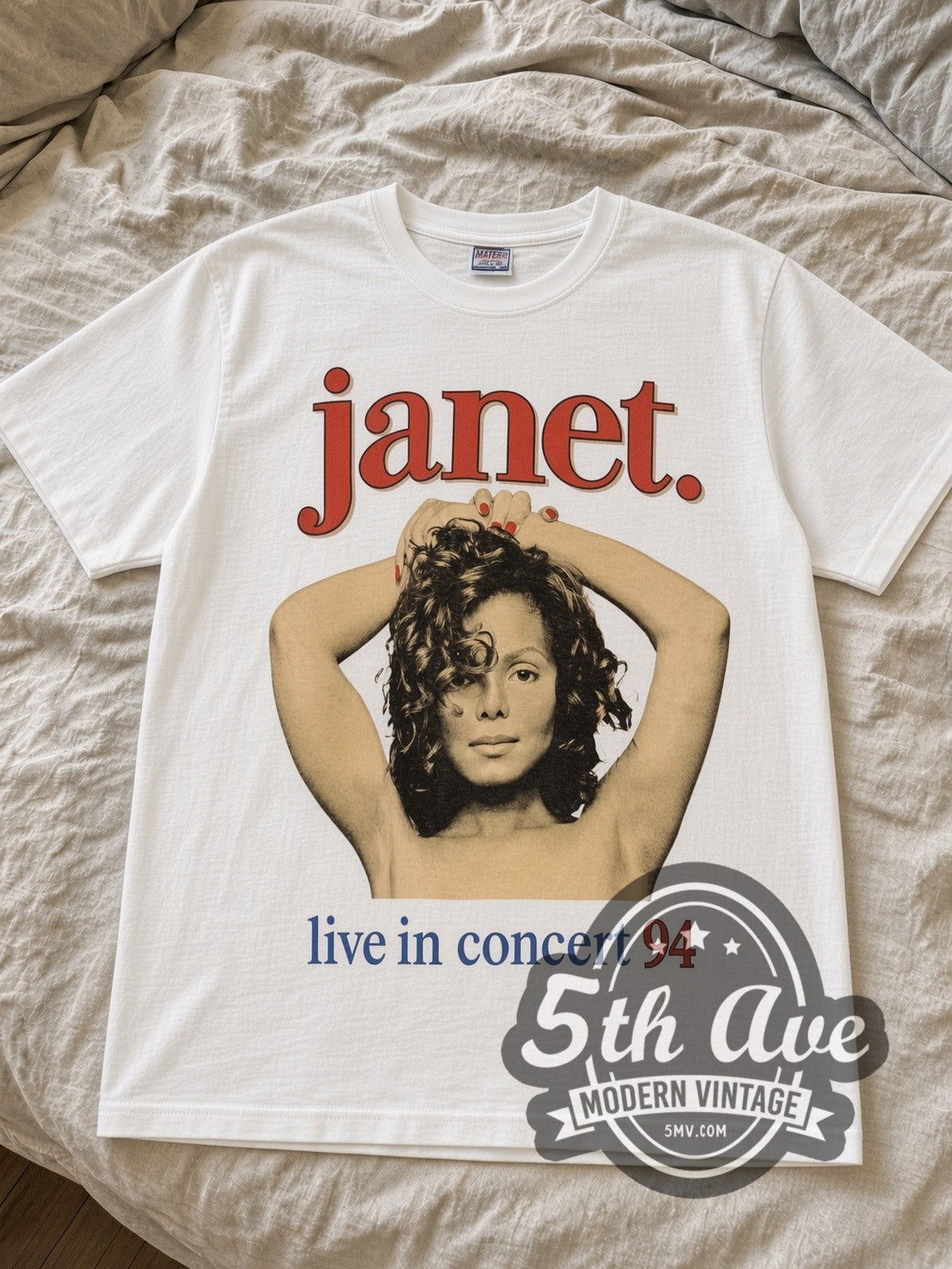 White Janet Jackson live in concert tee laid flat on linen bed