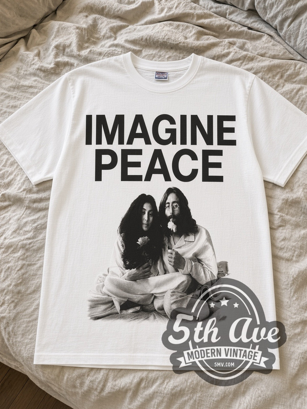 White John Lennon Imagine Peace tee laid flat on linen bed