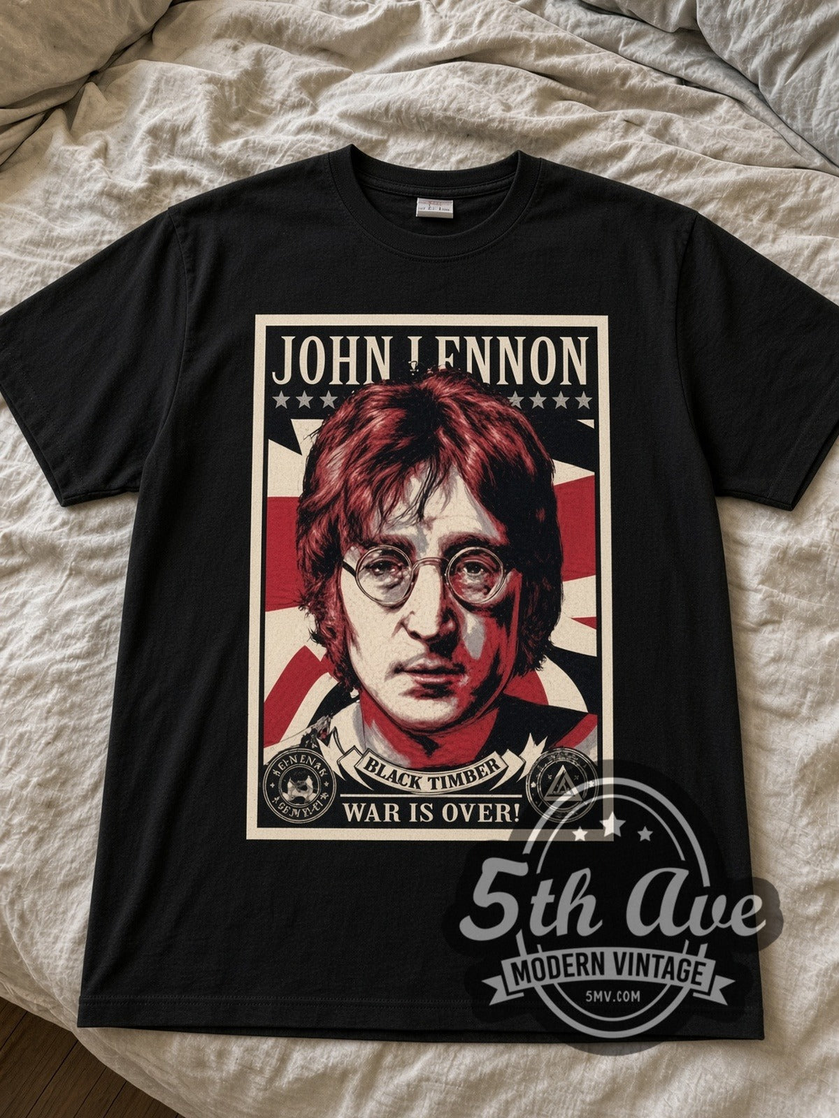 John Lennon War Is Over Portrait black graphic tee laid flat on linen bed